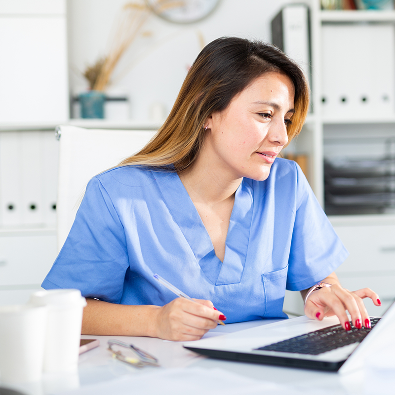 woman reading announcement on laptop